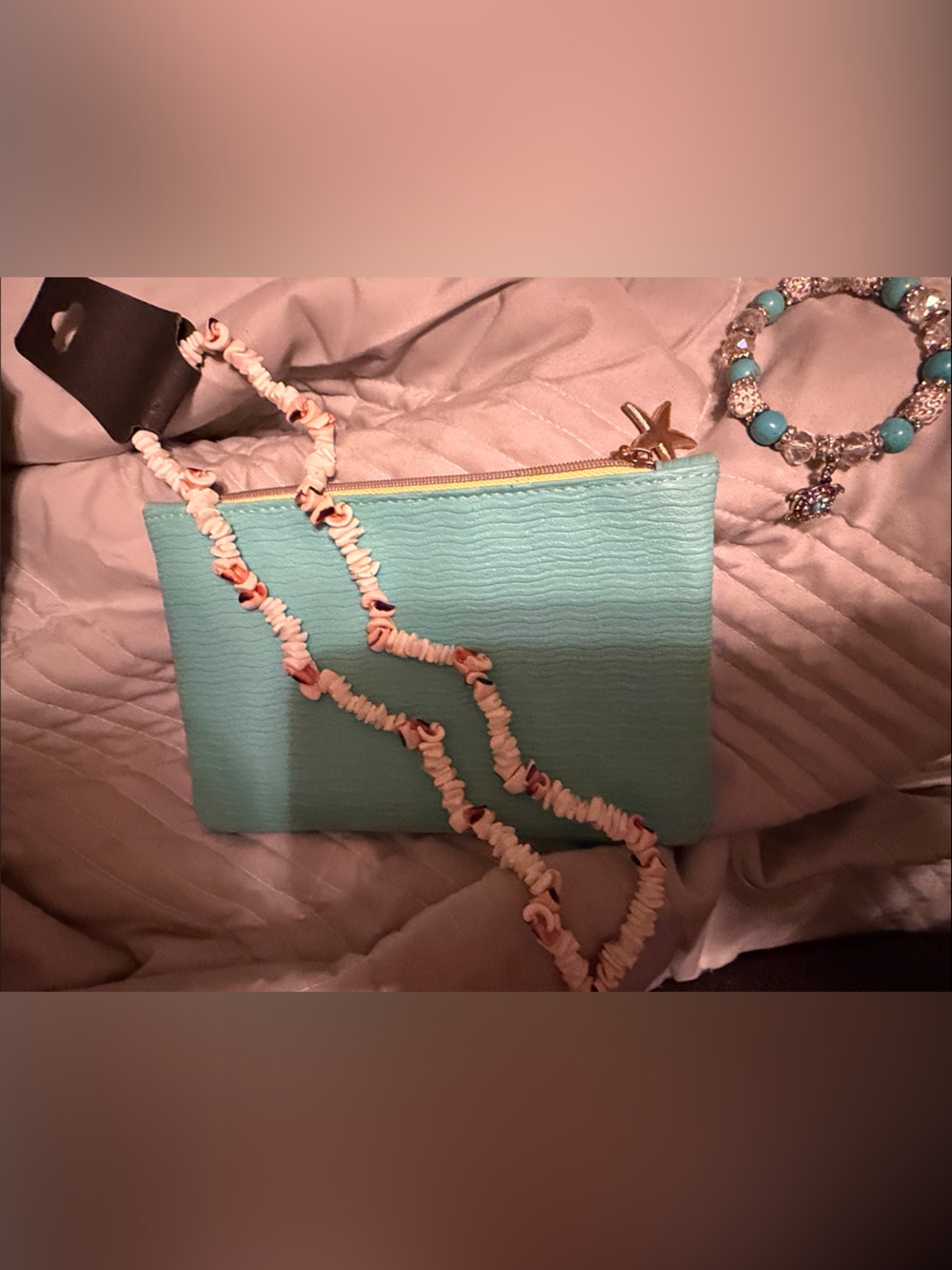 Turquoise Textured Ipsy bag with long shell necklace and turtle charm bracelet